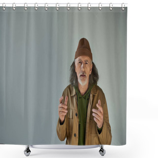 Personality  Upset And Worried Senior Bearded Man In Beanie Hat And Brown Jacket Gesturing And Looking At Camera On Grey Background, Hipster Clothes, Aging Population Lifestyle Concept Shower Curtains