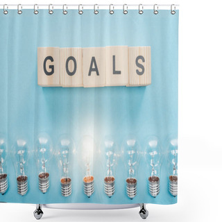 Personality  Top View Of Glowing Light Bulbs Under 'goals' Word Made Of Wooden Blocks On Blue Background, Goal Setting Concept Shower Curtains