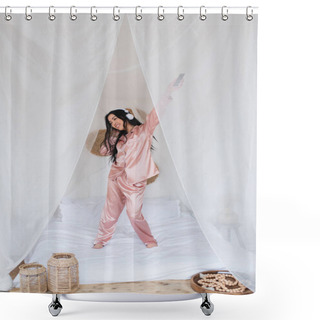 Personality  Positive Young Asian Woman Dancing On Bed With Headphones And Holding Cellphone With Outstretched Hand In Bedroom Shower Curtains