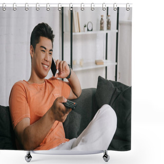 Personality  Handsome Asian Man Talking On Smartphone And Watching Tv While Sitting On Sofa At Home Shower Curtains