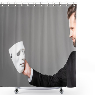 Personality  Side View Of Smiling Handsome Businessman In Black Suit Looking At White Mask Isolated On Grey Shower Curtains