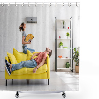 Personality  Exhausted Man Lying On Yellow Sofa Under Air Conditioner Near Woman With Hand Fan Shower Curtains