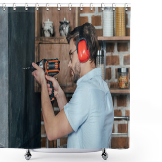 Personality  Side View Of Young Man In Eyeglasses And Earmuffs Drilling Wall With Electric Drill Shower Curtains