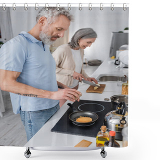 Personality  Side View Of Man Seasoning Pancake Near Blurred Wife Cutting Banana In Kitchen  Shower Curtains
