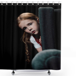 Personality  Anxious Child Looking At Camera While Hiding Behind Armchair Isolated On Black Shower Curtains