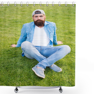 Personality  Opt For Simplicity Over Showiness. Fashion Man Sitting On Green Grass. Bearded Man In Fashion Denim Style Outdoor. Trendy Hipster With Long Beard Wearing Fashion Cap Backwards. Mens Summer Fashion Shower Curtains