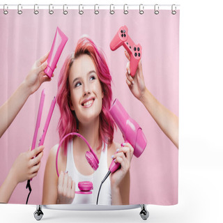 Personality  KYIV, UKRAINE - JULY 29, 2020: Young Woman With Colorful Hair Near Straightener, Headphones, Cosmetic Cream, Joystick And Hairdryer In Hands Isolated On Pink Shower Curtains