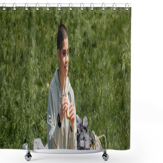 Personality  Positive Short Hared And Tattooed Tourist With Fitness Tracker Holding Sandwich And Looking Away While Sitting Near Backpack On Grassy Lawn, Connecting With Nature Concept, Banner, Summer Shower Curtains