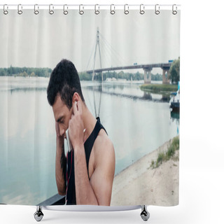 Personality  Athletic Bi-racial Man Adjusting Earphones While Standing Near River Shower Curtains