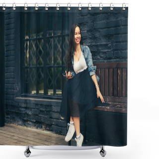 Personality  Beautiful Cheerful Young Woman Enjoying Recreation Time On Wooden Bench Outdoors In Urban Setting.Positive Female Looking Away While Sitting Near Black House.Promotional Background For Advertising Shower Curtains