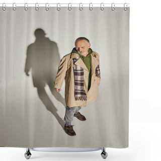 Personality  Full Length Of Aged And Bearded Man In Beige Trench Coat, Green Hoodie And Plaid Scarf Standing On Grey Background With Shadow, Trendy Casual Attire, Personal Style, High Angle View Shower Curtains