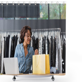 Personality  Cheerful African American Saleswoman Looking At Yellow Paper Bag Near Gadgets On Sales Counter Desk Shower Curtains