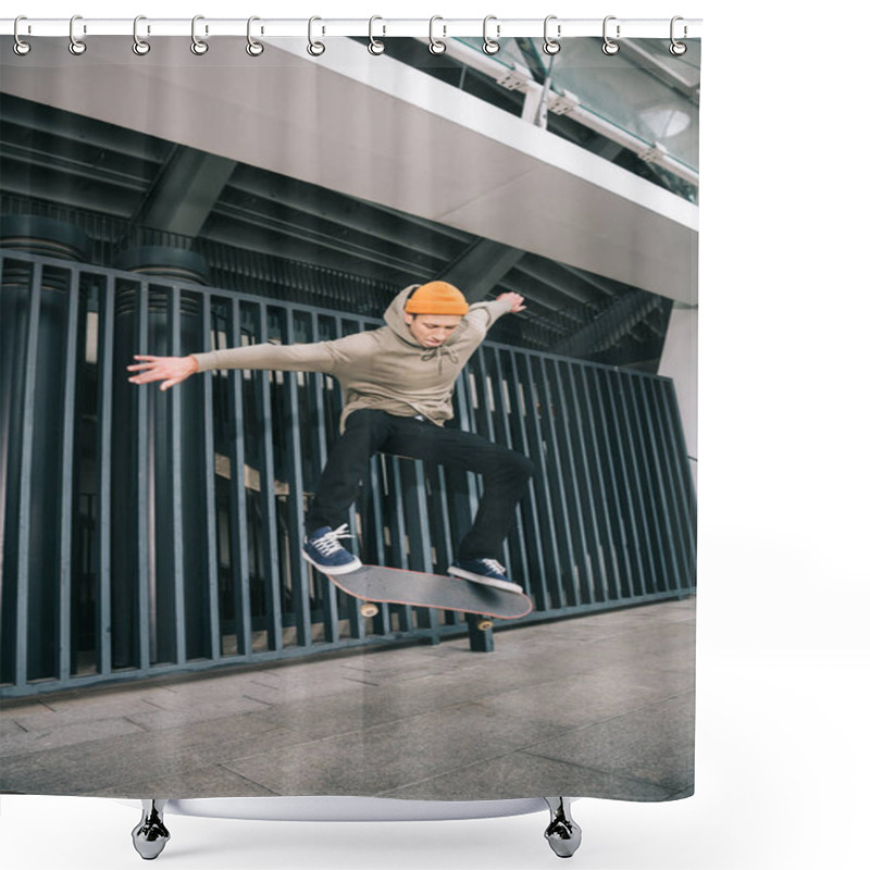 Personality  professional skateboarder performing trick in urban location shower curtains
