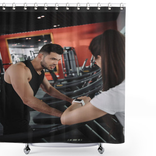 Personality  Personal Trainer Looking At Fitness Tracker While Standing Near Sportsman Running On Treadmill Shower Curtains