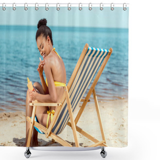 Personality  Smiling African American Woman Applying Sunscreen Lotion On Skin While Sitting On Deck Chair On Sandy Beach  Shower Curtains