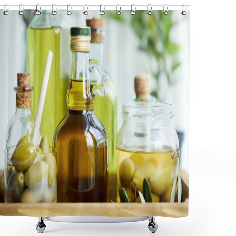 Personality  glass with spoon and green olives, jar, various bottles of aromatic olive oil with and branches on wooden tray shower curtains