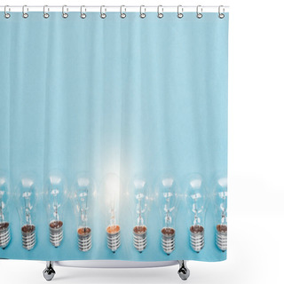 Personality  Top View Of Light Bulbs In Row And One Of Them Glowing On Blue Background, Having New Ideas Concept Shower Curtains