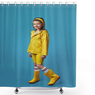 Personality  Little Girl In Yellow Raincoat And Sneakers Smiles While Standing Against Blue Shower Curtains