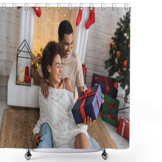 Personality  Joyful African American Couple With Christmas Present Sitting On Floor Near Fireplace  Shower Curtains