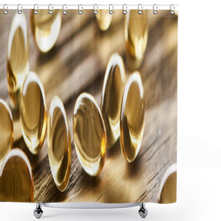 Personality  Close Up View Of Golden Fish Oil Capsules Scattered On Wooden Table, Panoramic Shot Shower Curtains