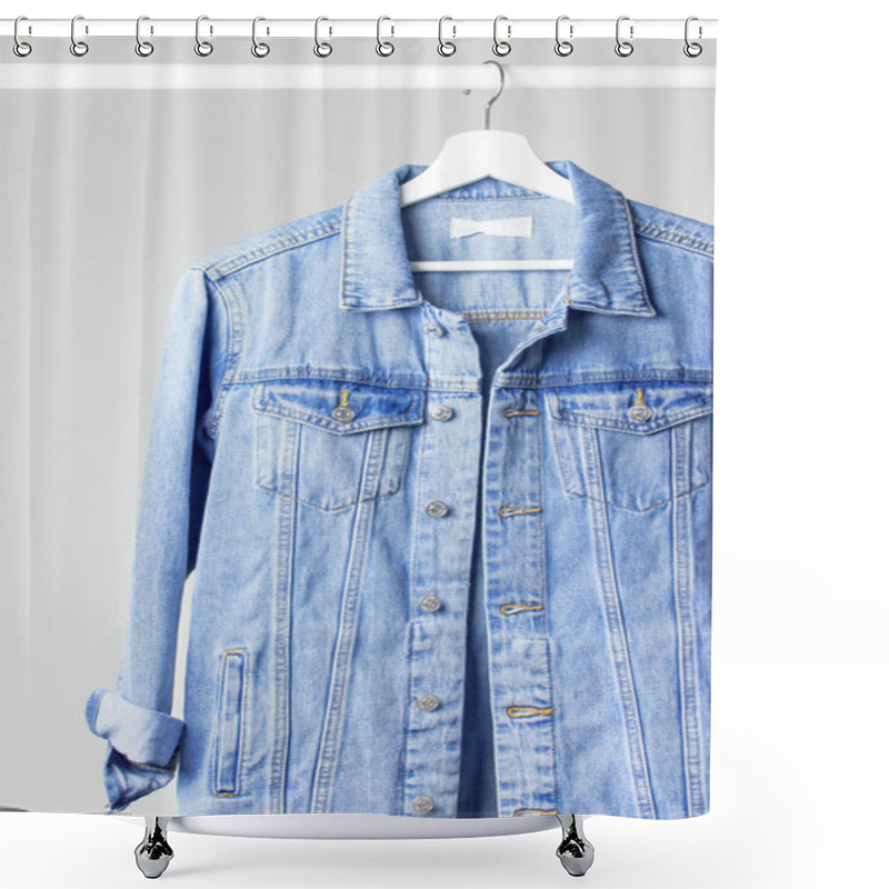 Personality  Blue denim jacket on white wooden coat hanger on a rod against light gray wall flat lay copy space. Denim, fashionable jacket, women's or men's trend clothing, fashion background. Store concept, sale shower curtains