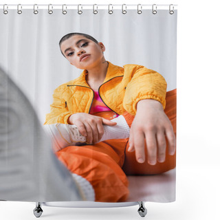 Personality  Outerwear, Fashion Statement, Tattooed Young Woman In Colorful Clothes Sitting And Looking At Camera On Grey Background, Urban Style, Individualism, Vibrant And Youthful Energy, Blurred Foreground   Shower Curtains