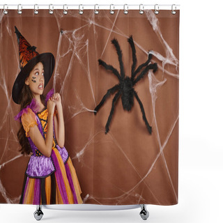 Personality  Girl In Witch Hat And Halloween Costume Grimacing Near Fake Spider And Cobwebs On Brown Background Shower Curtains