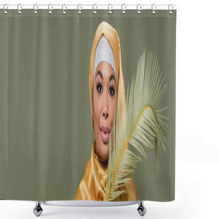 Personality  Young Multiracial Woman In Yellow Silk Hijab Smiling At Camera Near Leaf Of Tropical Plant Isolated On Green, Banner Shower Curtains
