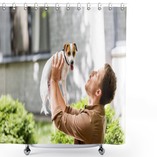 Personality  Young Man Raising Jack Russell Terrier Dog On Hands While Standing Outdoors Shower Curtains