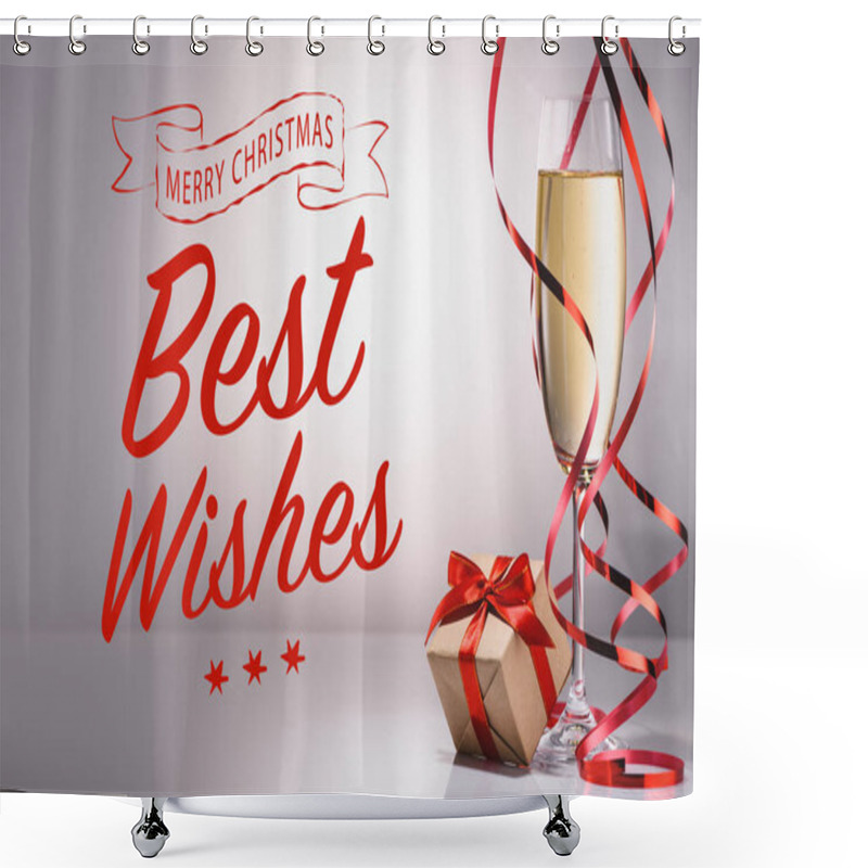 Personality  glass of champagne and wrapped gift on grey backdrop with 