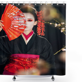Personality  Selective Focus Of Beautiful Geisha In Black Kimono With Red Flowers In Hair Holding Hand Fan In Front Of Face And Sakura Branches Isolated On Black Shower Curtains