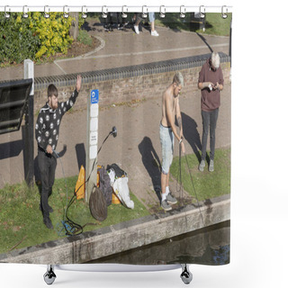 Personality  Young Man Throwing A Neodymium Magnet Into The Kennet And Avon Canal At Newbury, Berkshire, England UK Shower Curtains