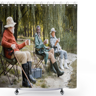 Personality  Smiling Multicultural Senior Men In Fishing Outfit With Thermo Cups Sitting Near Lake In Park  Shower Curtains