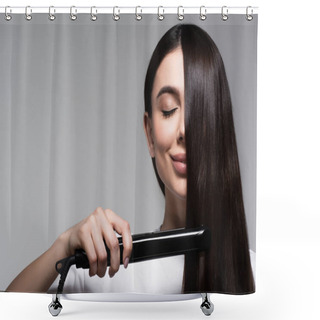 Personality  Pleased Brunette Woman Using Hair Straightener Isolated On Grey Shower Curtains