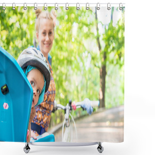 Personality  Mom On A Bike With A Small Child, Who Wore A Bicycle Helmet And  Shower Curtains