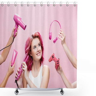 Personality  KYIV, UKRAINE - JULY 29, 2020: Young Woman With Colorful Hair Using Straightener Near Headphones, Cosmetic Cream, Joystick And Hairdryer In Hands Isolated On Pink Shower Curtains
