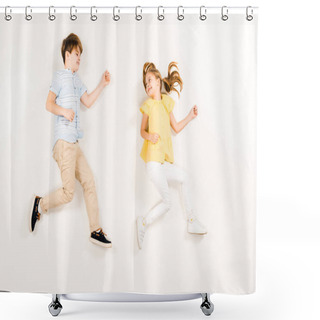 Personality  Top View Of Cheerful Kid Looking At Friend While Lying On White  Shower Curtains