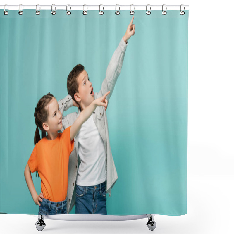 Personality  Happy Girl And Amazed Boy Pointing With Fingers While Looking Away Isolated On Blue Shower Curtains