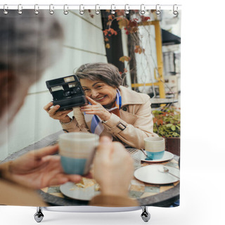 Personality  Happy Senior Woman Holding Vintage Camera And Taking Photo Of Blurred Husband With Cup Of Tea Shower Curtains