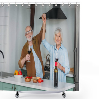 Personality  Happy Senior Couple With Wine Glasses Looking At Camera While Having Fun Near Table With Food In Kitchen Shower Curtains