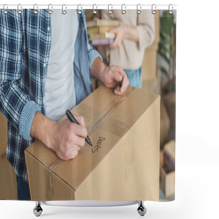 Personality  Cropped Shot Of Man Signing Cardboard Box With Wife With Books In Hands Near By, Moving Home Concept Shower Curtains