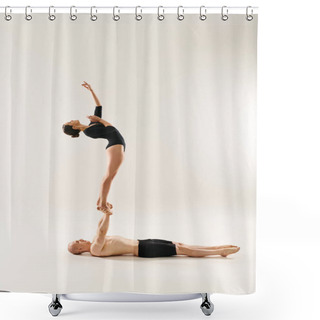 Personality  A Young Shirtless Man And A Woman Showcase Incredible Balance And Teamwork By Doing Acrobatic Pose Together In A Studio Setting. Shower Curtains