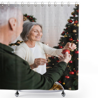 Personality  Mature Man Giving Christmas Toy To Cheerful Wife Decorating Pine Tree At Home Shower Curtains