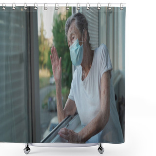Personality  Portrait Of Masked Senior Woman In Late 90s Waving From Home Window. Elderly Woman In Protective Mask Looks Out The Window And Waves Her Hand While Isolating At Home And Conducting Social Distancing. Shower Curtains