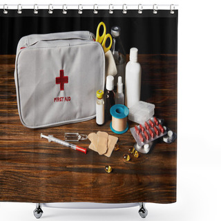 Personality  Close-up Shot Of First Aid Kit With Different Medicines On Wooden Tabletop And On Black Shower Curtains