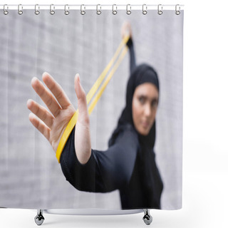 Personality  Selective Focus Of Arabian Sportswoman In Hijab Exercising With Resistance Band Near Brick Wall Shower Curtains
