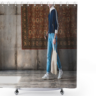 Personality  Cropped Shot Of Man In Old School Clothes With String Bag And Bottle Of Beer In Front Of Rug Hanging On Wall Shower Curtains
