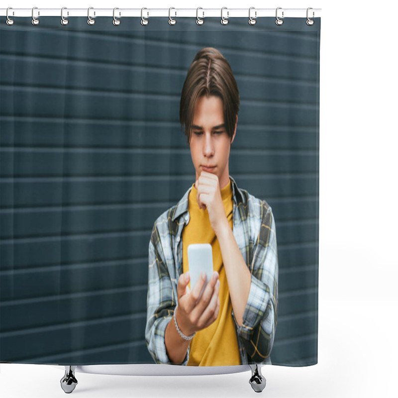 Personality  Pensive teenager using smartphone near building outdoors  shower curtains