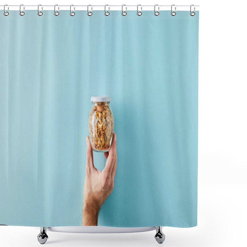 Personality  Cropped view of man holding jar of granola on blue background shower curtains