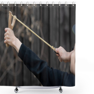 Personality  A Boy In A Black Jacket With A Hood And A Cap Shoots From A Slingshot, Blurred Background Shower Curtains